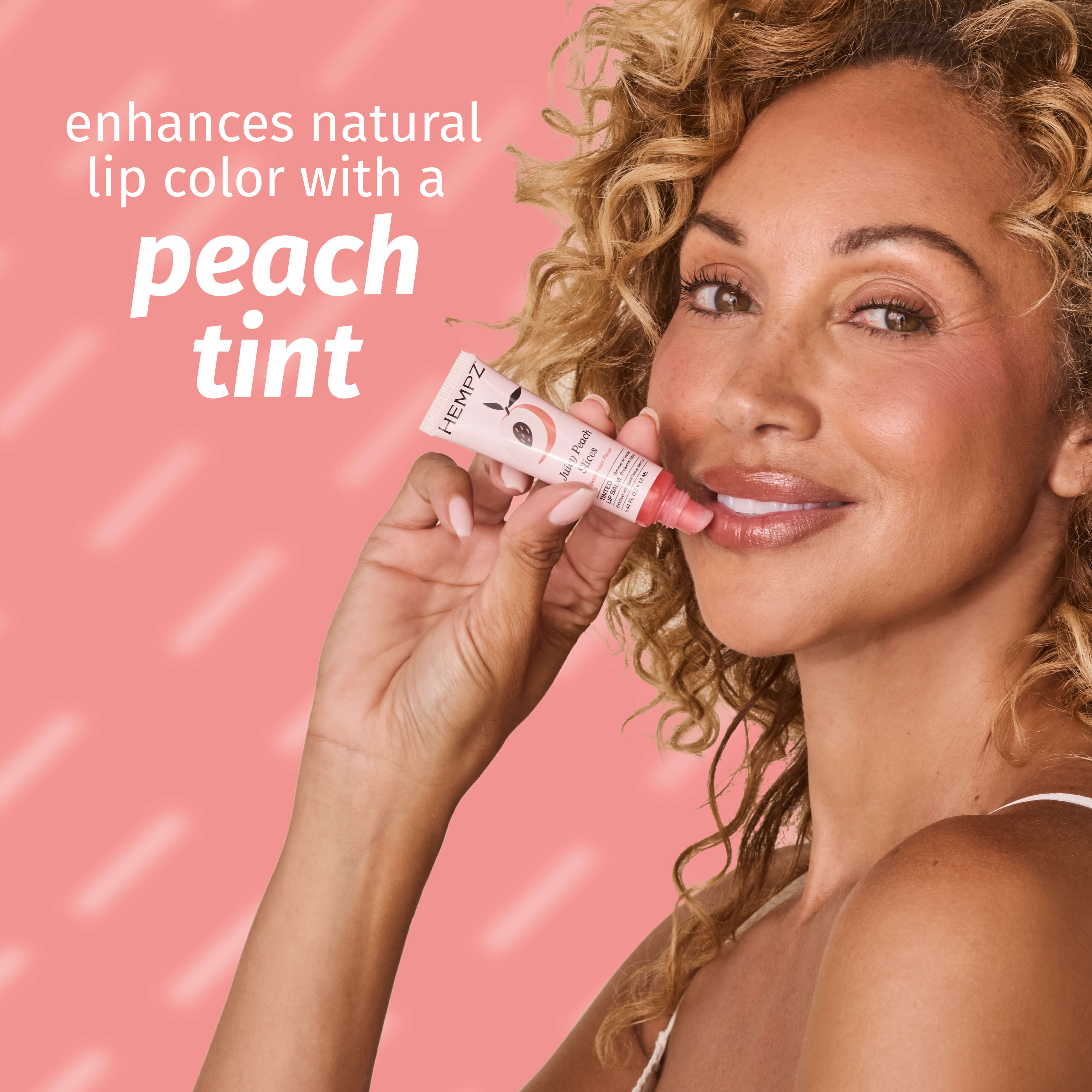 Woman holding a lip tint with text on a pink background